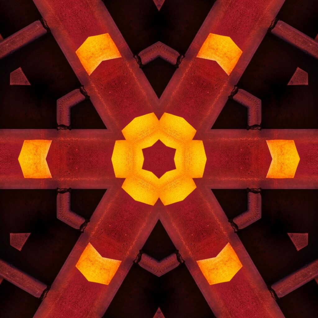 Vibrant and colorful abstract geometric pattern resembling a kaleidoscope or stained glass design.